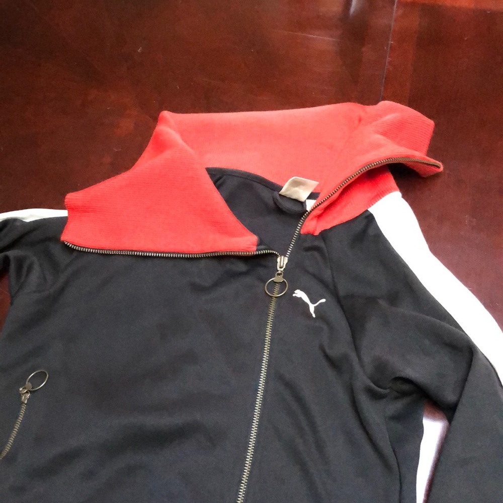 Super unique and fashion forward asymmetrical Puma jacket with a bold collar.